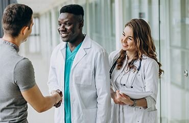 doctors shaking hands with patient